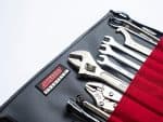 Toolset for motorcycle repair with Revelry Motorcycles branding, open toolbox with wrenches and pliers.