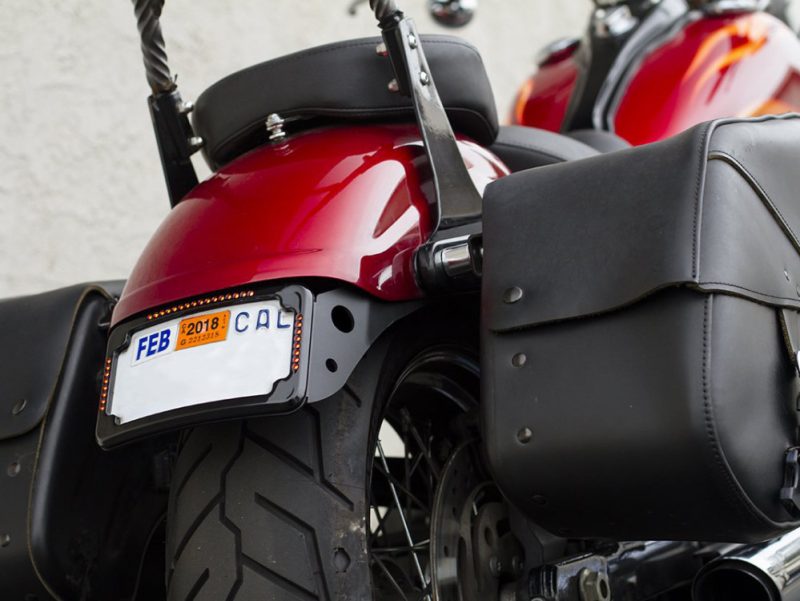 Motorcycle with black leather saddlebags and red glossy finish for sale on Revelry Cycles.