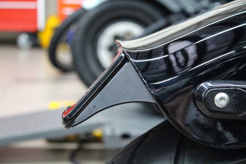 High-quality motorcycle frame close-up at Revelry Motorcycles, showcasing the sleek black design and craftsmanship.