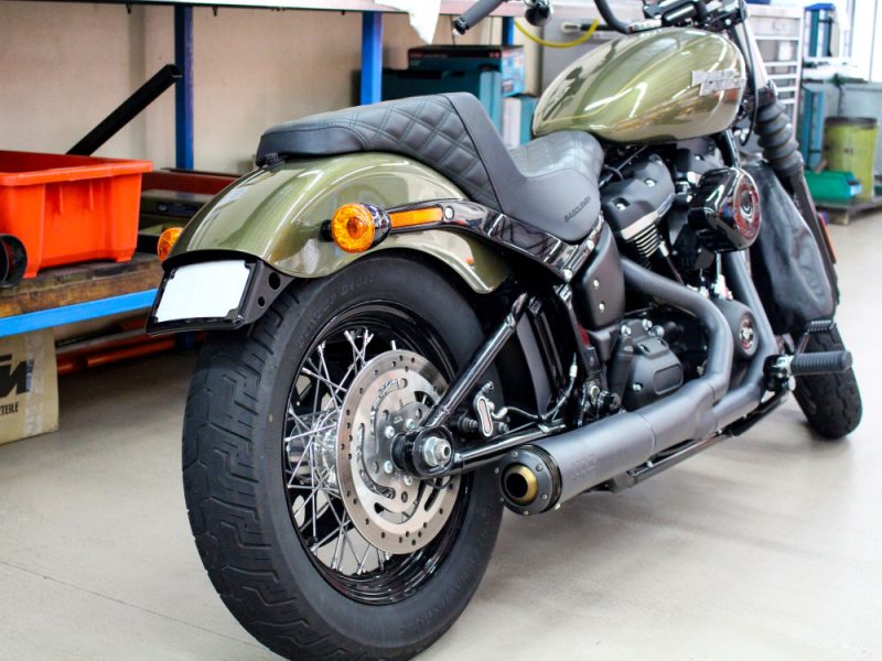 Harley-Davidson motorcycle in olive green with black accents, modern custom build.