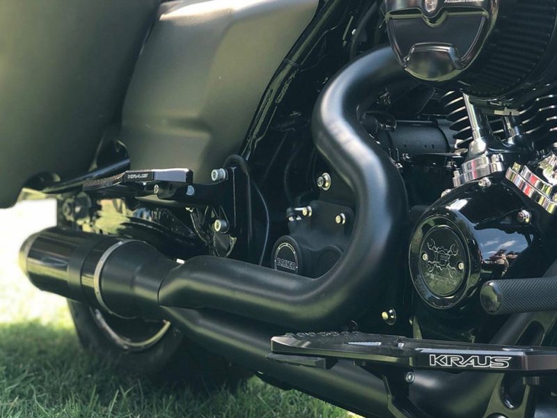 High-performance black motorcycle exhaust system on a sleek Revelry Motorcycle.