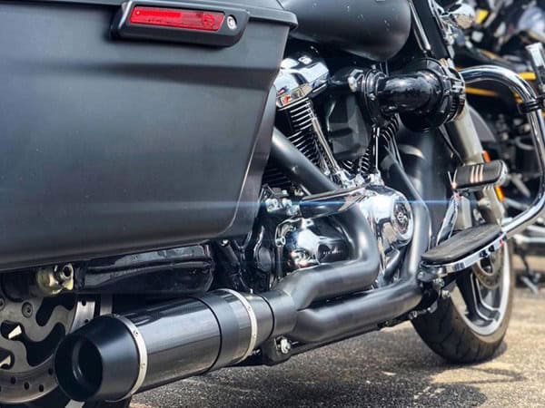 Bob Cat 2-into-1 Exhaust - Black with Black Satin Sleeve Muffler. Fits Touring 2017up. High-performance motorcycle engine with sleek exhaust system at Revelry Motorcycles, Australian bike shop.