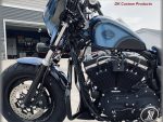 Harley Davidson motorcycle with custom black and blue paint, chrome details, and powerful engine.