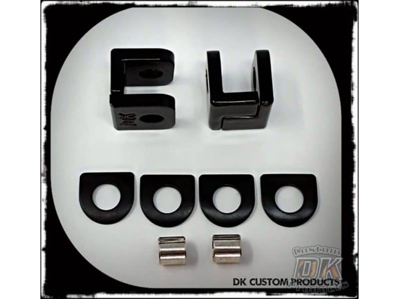 Black number 34 and four mounting spacers for motorcycle customisation or repair.