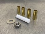 Brass and metal spacers with nut and washer for motorcycle maintenance and upgrades.