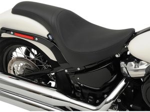 Sleek black motorcycle seat with chrome exhaust pipe - perfect for Harley Davidson enthusiasts.