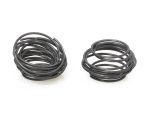 Coil springs for motorcycle suspension, black rubber shocks, high-performance bike parts.