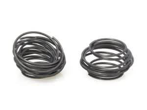 Coil springs for motorcycle suspension, black rubber shocks, high-performance bike parts.