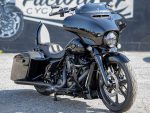 Black touring motorcycle with aerodynamic fairing and comfortable seat, ideal for long rides.