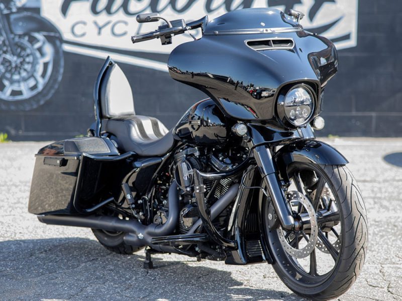 Black touring motorcycle with aerodynamic fairing and comfortable seat, ideal for long rides.