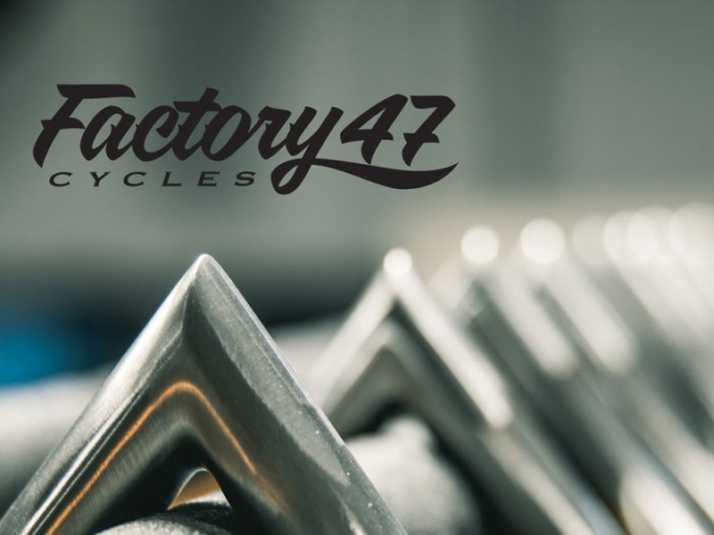 Factory 47 Motorcycles logo on a bicycle frame, close-up shot.
