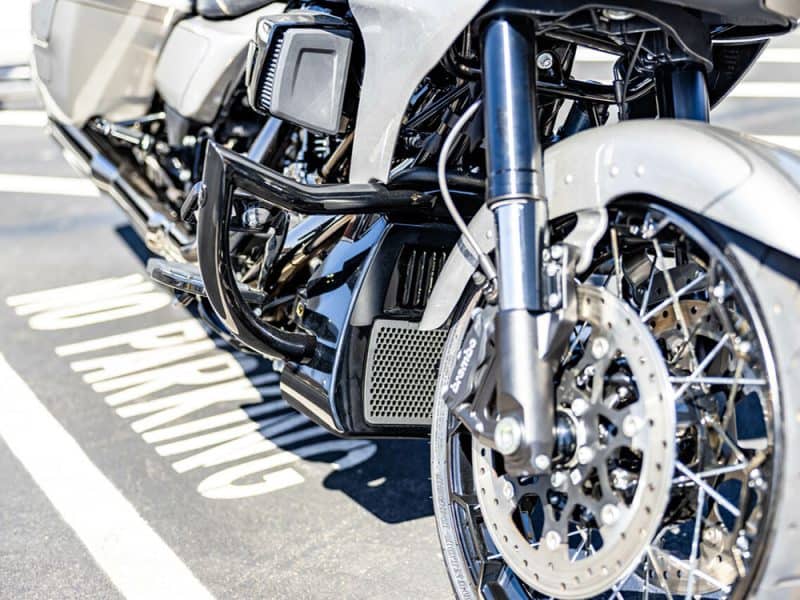 High-performance touring motorcycle with advanced suspension and braking systems, parked in a designated space.