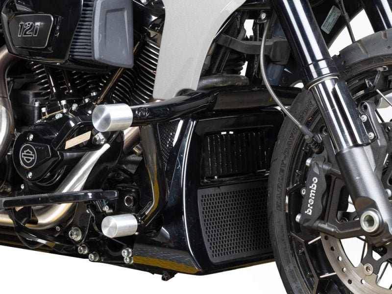 Harley-Davidson motorcycle engine and front suspension with Brembo brake caliper, close-up shot.