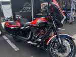 Harley-Davidson touring motorcycle with black and red accents at Revelry Motorcycles event.