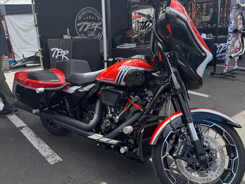 Harley-Davidson touring motorcycle with black and red accents at Revelry Motorcycles event.
