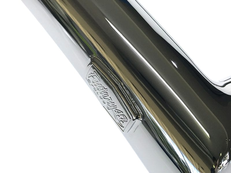 Chrome motorcycle exhaust with Ford logo detail, showcasing premium quality and sleek design.