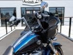 Harley-Davidson touring motorcycle with black and blue finish, featuring premium audio system and touring windshield.