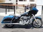 Harley-Davidson touring motorcycle in black and blue with chrome accents, ideal for long-distance rides.
