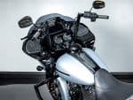 Shiny black and silver Harley-Davidson touring motorcycle with digital dashboard and mirrors.