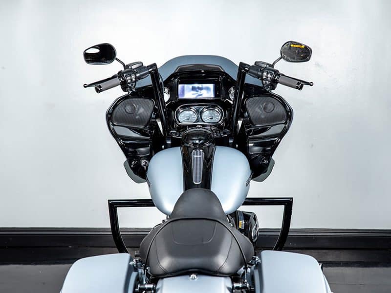 High-end black touring motorcycle with advanced digital dashboard and audio speakers for enthusiasts.