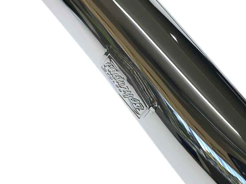 Polished motorcycle exhaust pipe with Revelry Motorcycles branding.