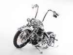 Shiny custom chrome motorcycle with high handlebars and vintage style, perfect for motorcycle enthusiasts.