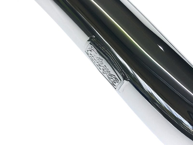 Motorcycle exhaust pipe with Revelry Cycles branding, high-quality chrome finish.