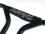 Vintage black bicycle handlebar with "Factory 44 Cycles" branding for Revelry Motorcycles.