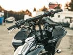 Sleek black Harley-Davidson touring motorcycle with advanced dashboard and audio system.