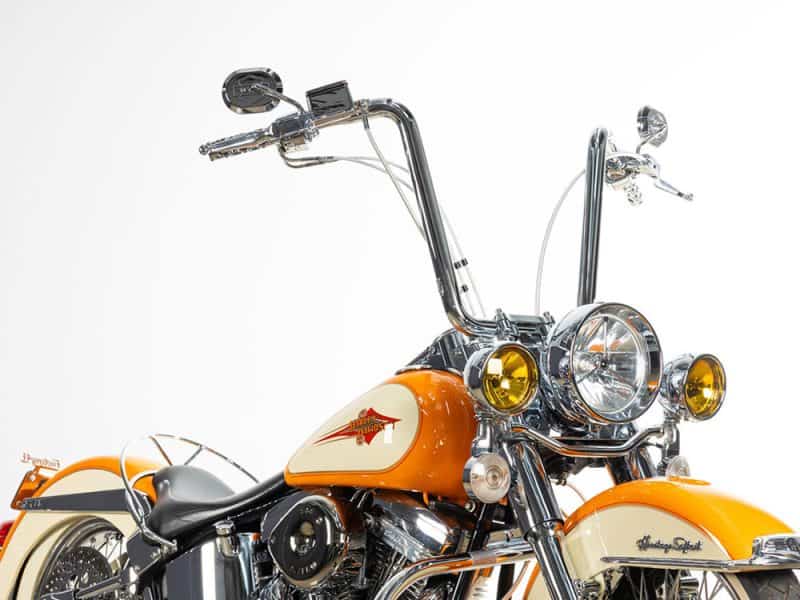 Vibrant orange and cream Harley Davidson motorcycle with chrome accents for sale at Revelry Cycles.