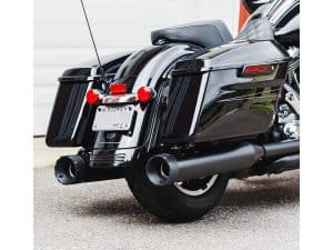 A black touring motorcycle with saddlebags and dual exhaust pipes.