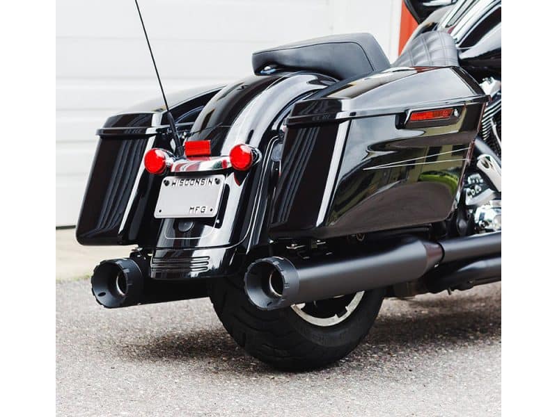 A black touring motorcycle with saddlebags and dual exhaust pipes.