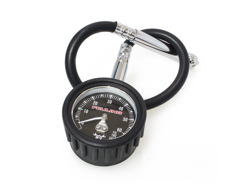 High-pressure tire gauge with carabiner clip for motorcycle maintenance and safety.