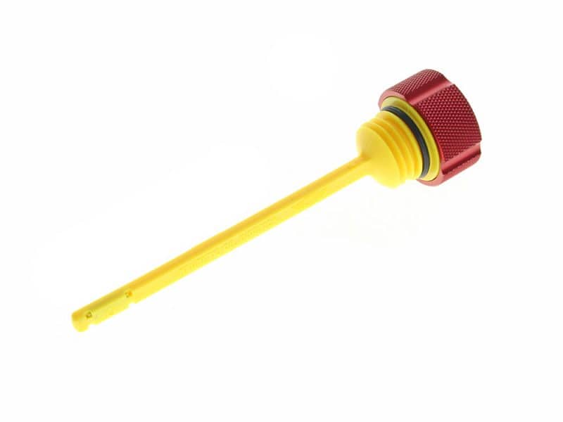 Yellow KTM oil cap with red knurled grip for motorcycle engine maintenance.