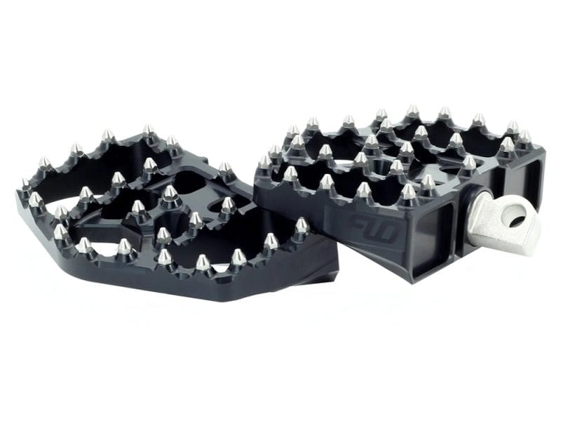 Heavy-duty motorcycle foot pegs with traction spikes for off-road riding, aluminium construction for durability.