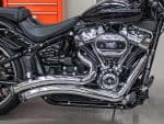 Vivid black Harley-Davidson motorcycle with chrome engine and exhaust, showcased at Revelry Motorcycles.
