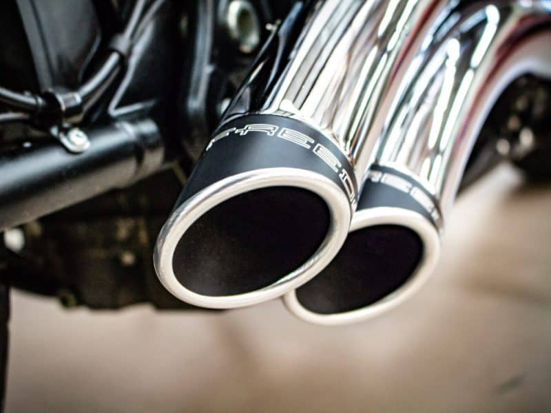 Twin chrome exhaust pipes on a motorcycle.