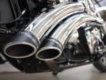 High-performance motorcycle exhaust pipes with chrome finish at Revelry Motorcycles Australia.