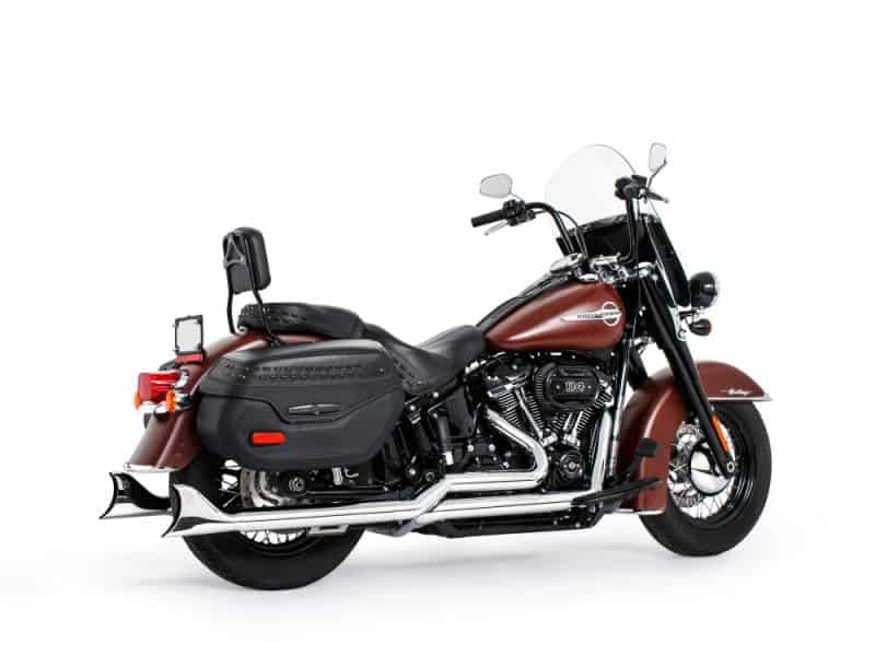 Harley-Davidson touring motorcycle with leather saddlebags and chrome exhausts.