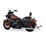 High-quality brown and black Harley-Davidson touring motorcycle with saddle bags and chrome exhausts for sale.