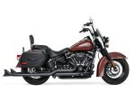 Black and brown Harley Davidson motorcycle with saddlebags, classic cruiser style, and custom detailing.