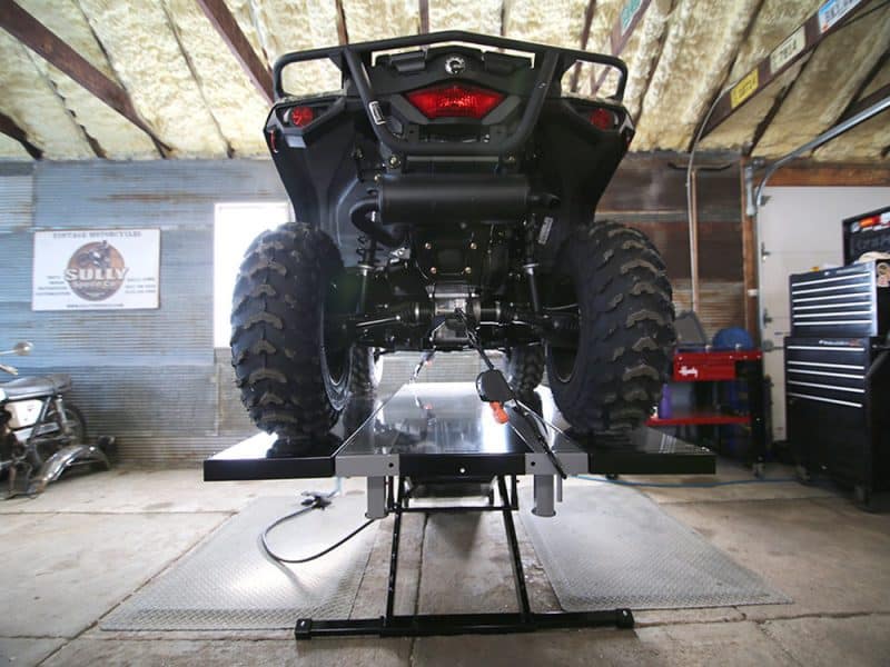 Rugged all-terrain Revelry motorcycle in workshop with lift, showcasing off-road adventure bikes Australian market.