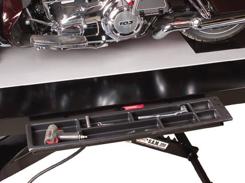 Revelry Motorcycles custom motorcycle workshop with tools and parts, specialising in Harley-Davidson and cruiser bikes.