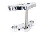 Polished motorcycle handlebar riser for custom cafe racer builds.
