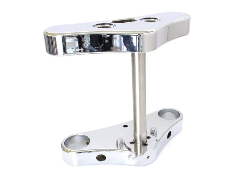 Polished motorcycle handlebar riser for custom cafe racer builds.
