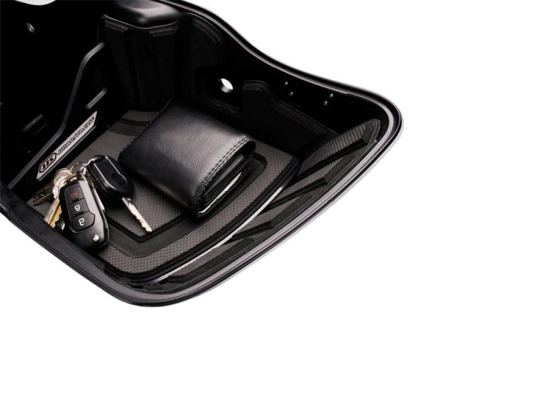 Leather motorcycle key wallet with keys in Revelry Cycles storage compartment.