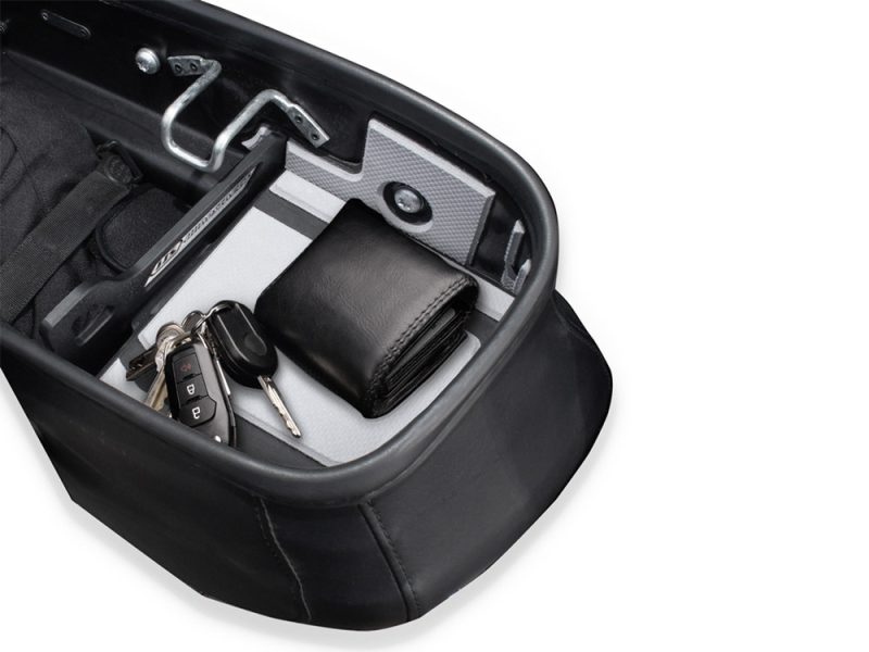 Keys and wallet inside motorcycle pannier for touring motorcycle rides.