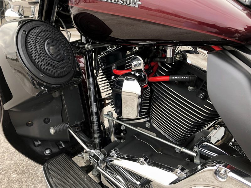 Vivid close-up of Harley Davidson motorcycle engine with chrome and black components.