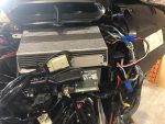 High-performance motorcycle electronics installation with wiring and cooling system.