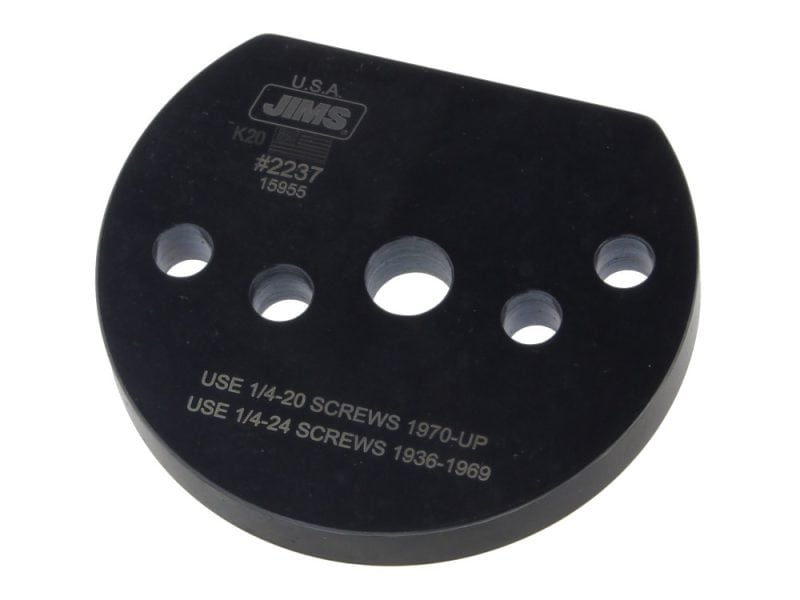 Black motorcycle spacer with multiple holes, suitable for vintage and custom bikes.